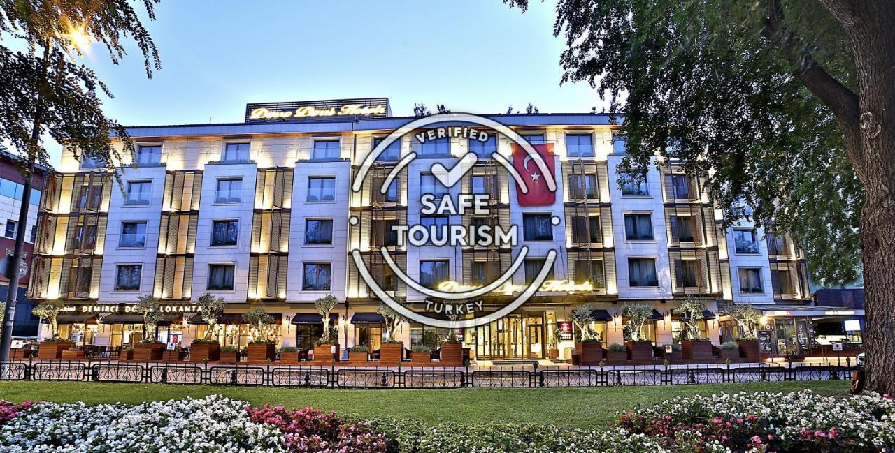 ดอสโซ่ ดอสซี่ โฮเต็ล แอน์ สปา ดาวน์ทาวน์ Hotel อิสตันบูล ภายนอก รูปภาพ The photo shows a modern hotel building, prominently featuring a well-lit façade. In front of the hotel, there are landscaped gardens with colorful flowers. Overlaying the image is a "Verified Safe Tourism" badge, indicating that the location meets c