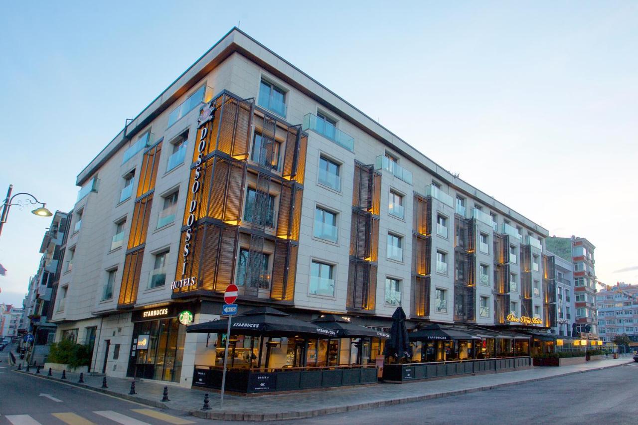 ดอสโซ่ ดอสซี่ โฮเต็ล แอน์ สปา ดาวน์ทาวน์ Hotel อิสตันบูล ภายนอก รูปภาพ The photo shows a modern building that appears to be a hotel. It has a contemporary architectural design with a mix of light-colored walls and wooden accents. The structure is four stories high and features large windows that allow for plenty of natu